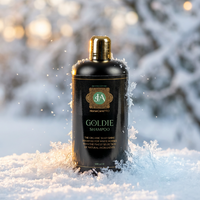 Goldie shampoo bottle in the snow with a blurred winter background